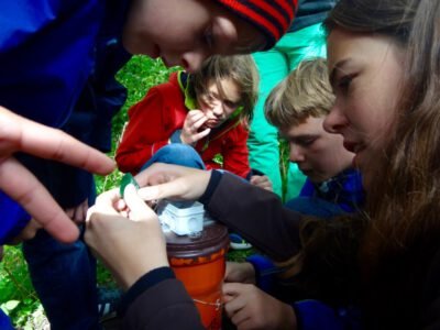 a group of kids looking at a piece of paper