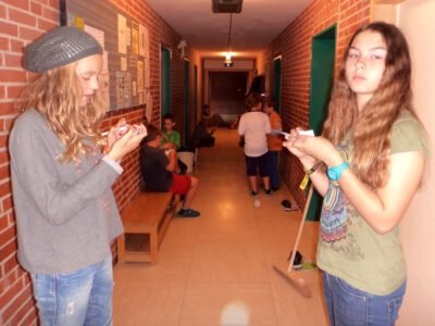 a group of girls standing in a hallway