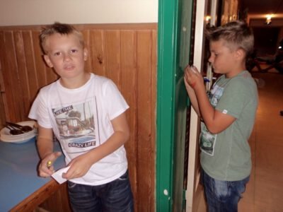 a boy standing next to another boy