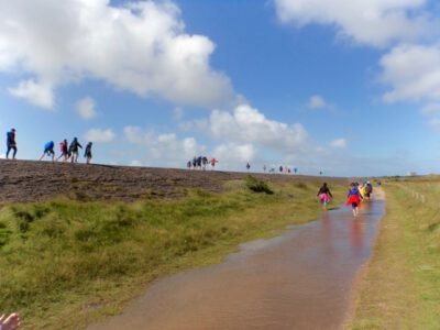 a group of people walking in a stream