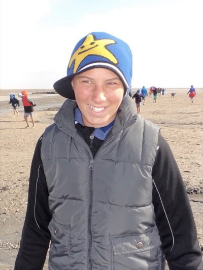 a person wearing a hat and vest