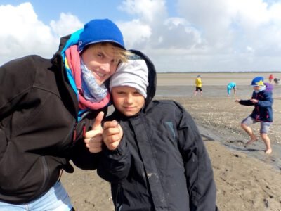 a woman and boy on a beach