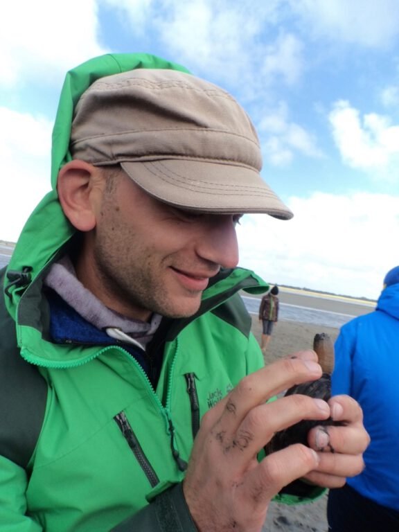 a man holding a small animal