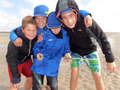 a group of boys on a beach