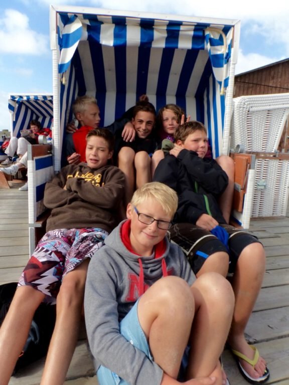 a group of boys sitting in a chair