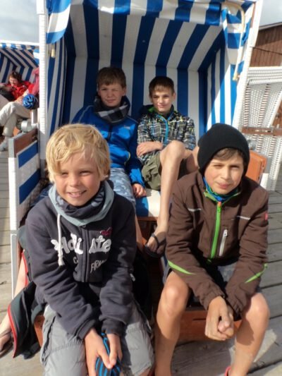 a group of boys sitting in a chair