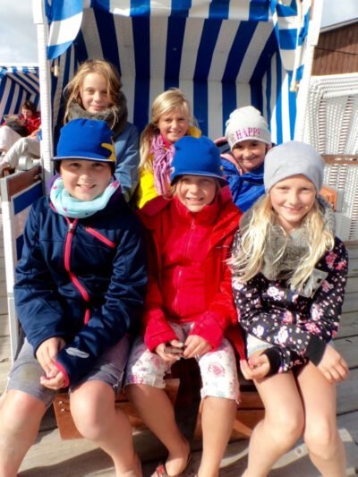 a group of children sitting on a chair