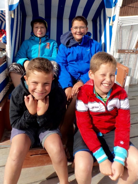 a group of kids sitting in a striped chair