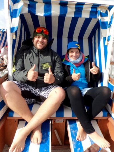 a man and woman sitting in a beach chair