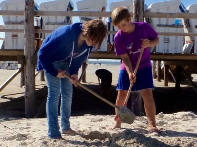 two children digging in the sand