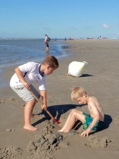 two boys playing on the beach