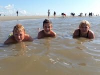 a group of kids lying in the water