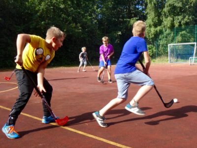 a group of kids playing hockey