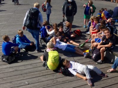 a group of children sitting on a wooden surface