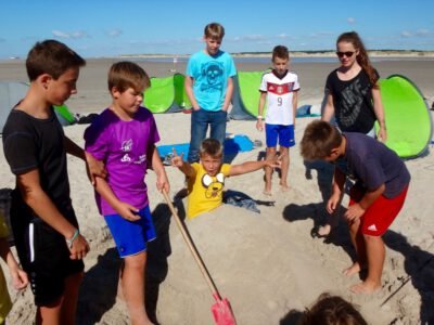 a group of kids playing in the sand