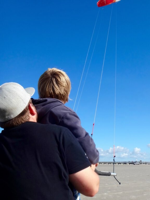 a man and child flying a kite