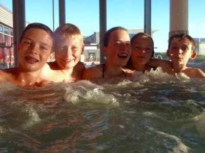 a group of kids in a hot tub
