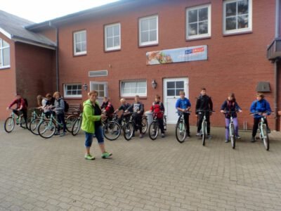 a group of people on bicycles outside of a building