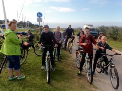 a group of people riding bicycles on a road
