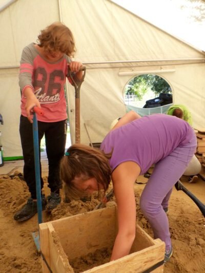 a group of people digging in sand