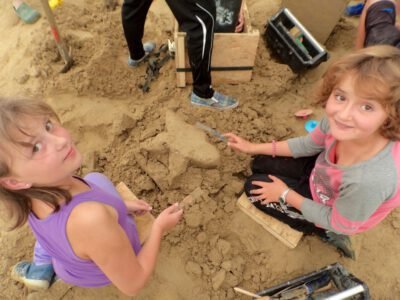 a group of girls playing in the sand