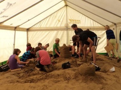 a group of kids building sand castles in a tent