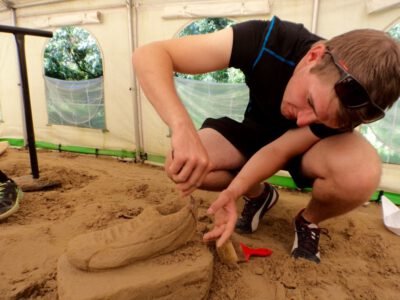 a man kneeling in the sand