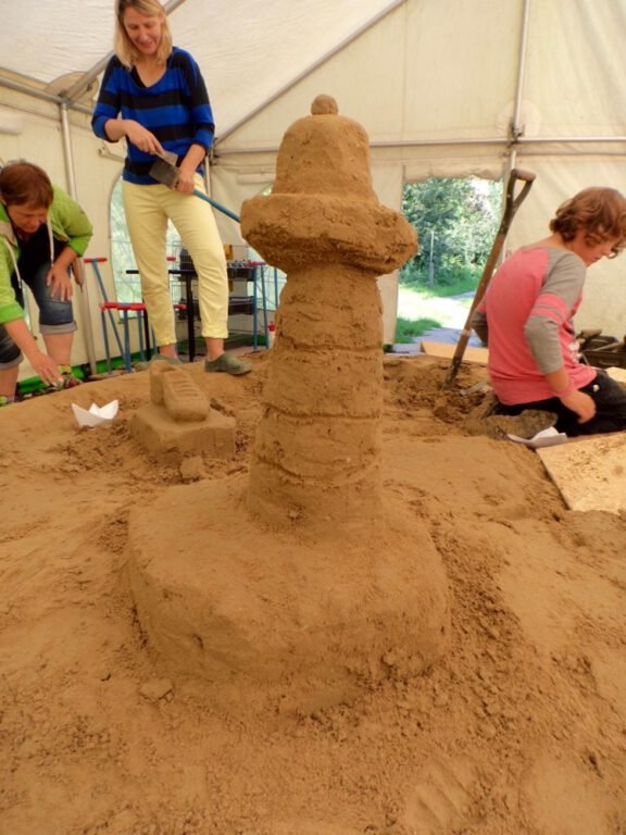 a group of people building sandcastles
