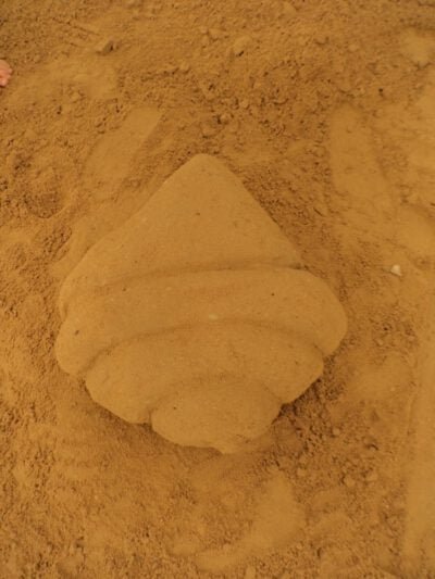 a croissant shaped object on sand