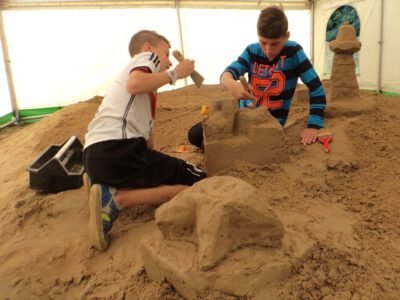 two boys building sand castles