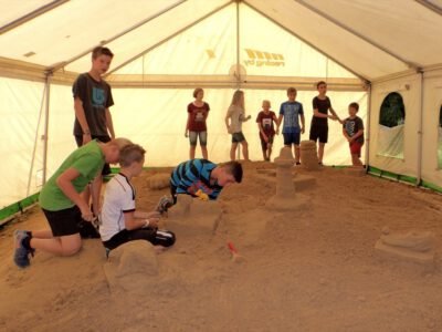 a group of kids playing in sand