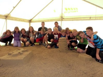 a group of people posing for a photo in a tent