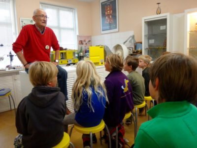 a man standing in front of a group of kids