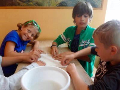 a group of kids sitting at a table