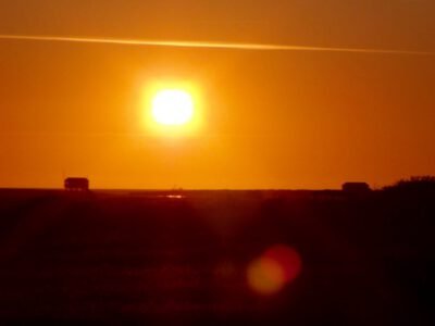 a sunset over a field