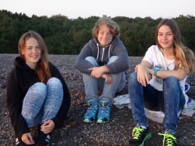 a group of people sitting on a rocky surface