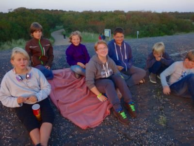 a group of children sitting on a blanket