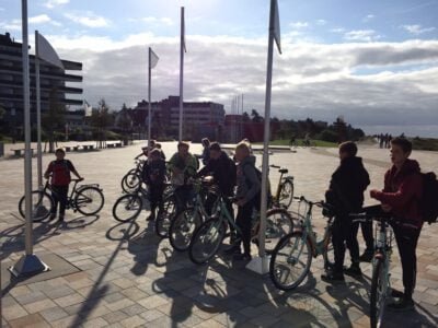 a group of people standing next to bicycles