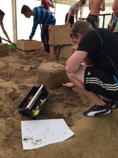 a group of people working on sand