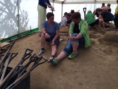 a group of people sitting in a sand pit