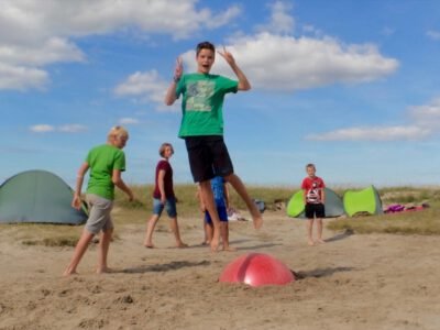 a group of kids playing on a beach