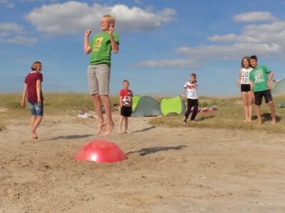 a group of kids playing in the sand
