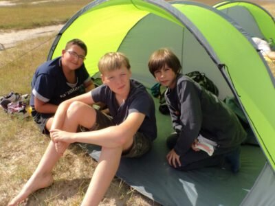 a group of boys sitting in a tent