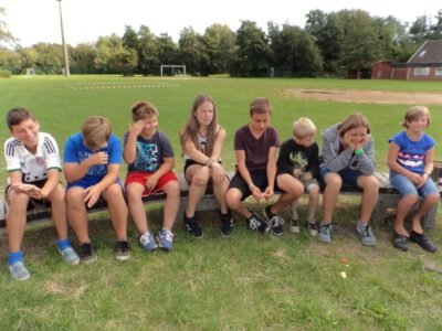 a group of kids sitting on a bench