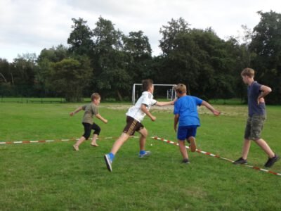 a group of boys playing a game on a field