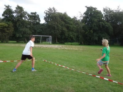 a boy and girl playing with a ball