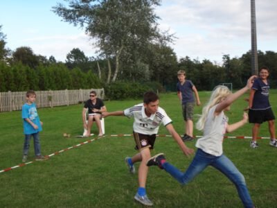 a group of kids playing with a frisbee