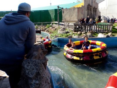 a group of people in tubs in a river