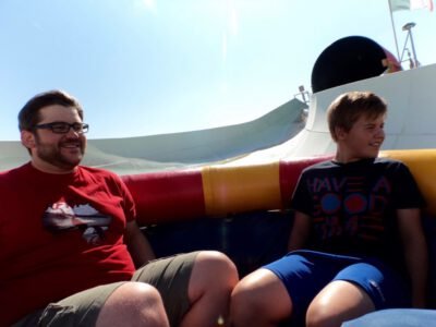 a group of men sitting on a slide