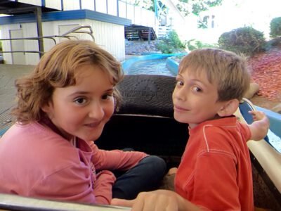 a couple of kids sitting in a ride